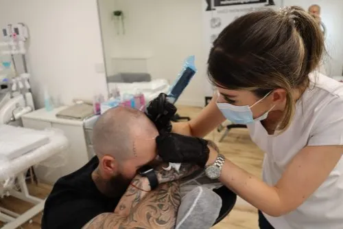 Rebecca Brown performing scalp micropigmentation (SMP) treatment at Permanent Perfection