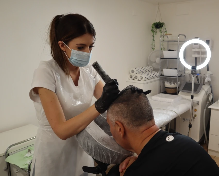 Rebecca Brown performing a treatment on thinning hair